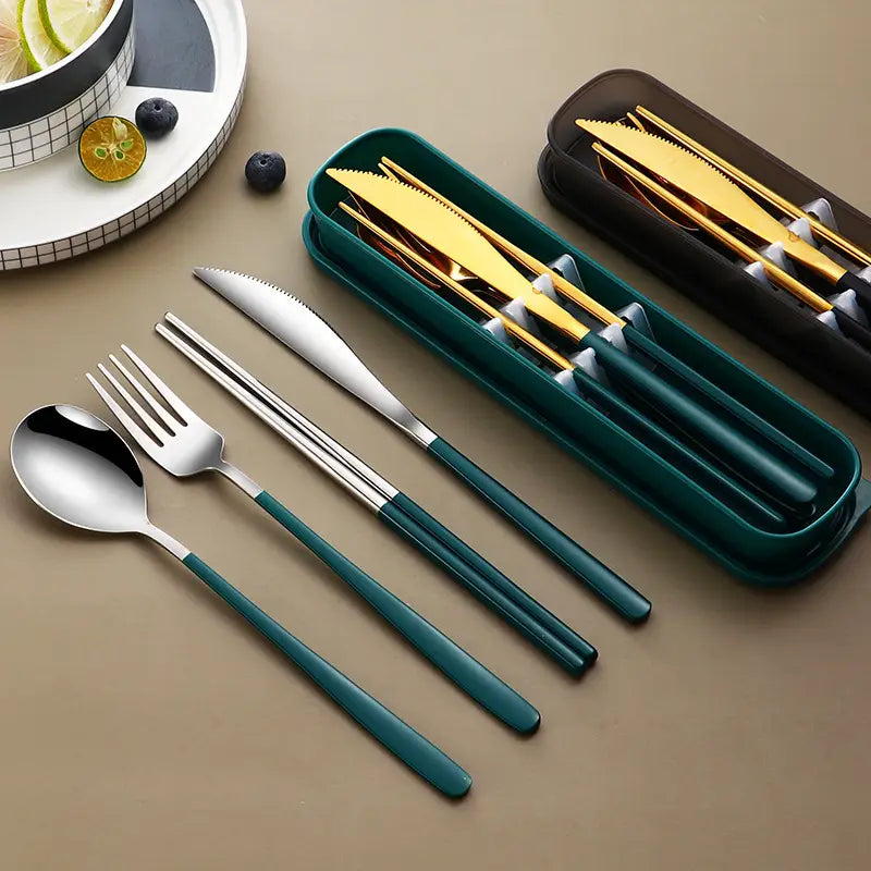 Stainless steel portable cutlery set with teal handles and gold-accented blades neatly arranged in a matching green carrying case.