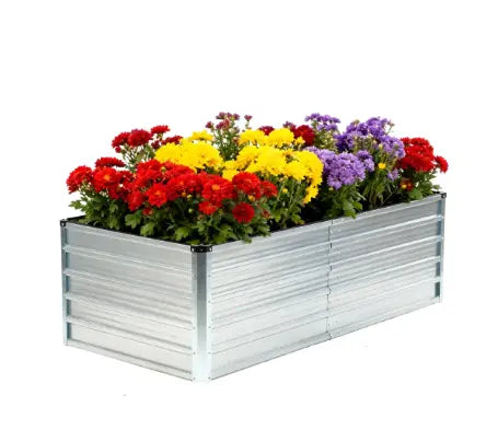 Rectangular galvanized metal planter box 6x3x2ft filled with vibrant red yellow and purple chrysanthemums for raised garden bed use.