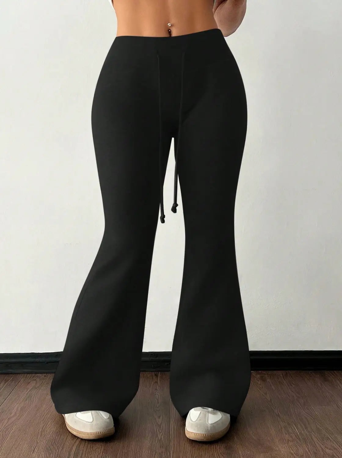 black high-waisted flared fleece lined sweatpants with a drawstring waistband designed for comfort and warmth