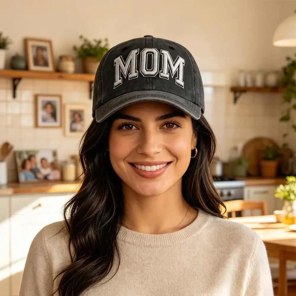 Black baseball cap with mom embroidered in white lettering featuring a vintage washed finish.