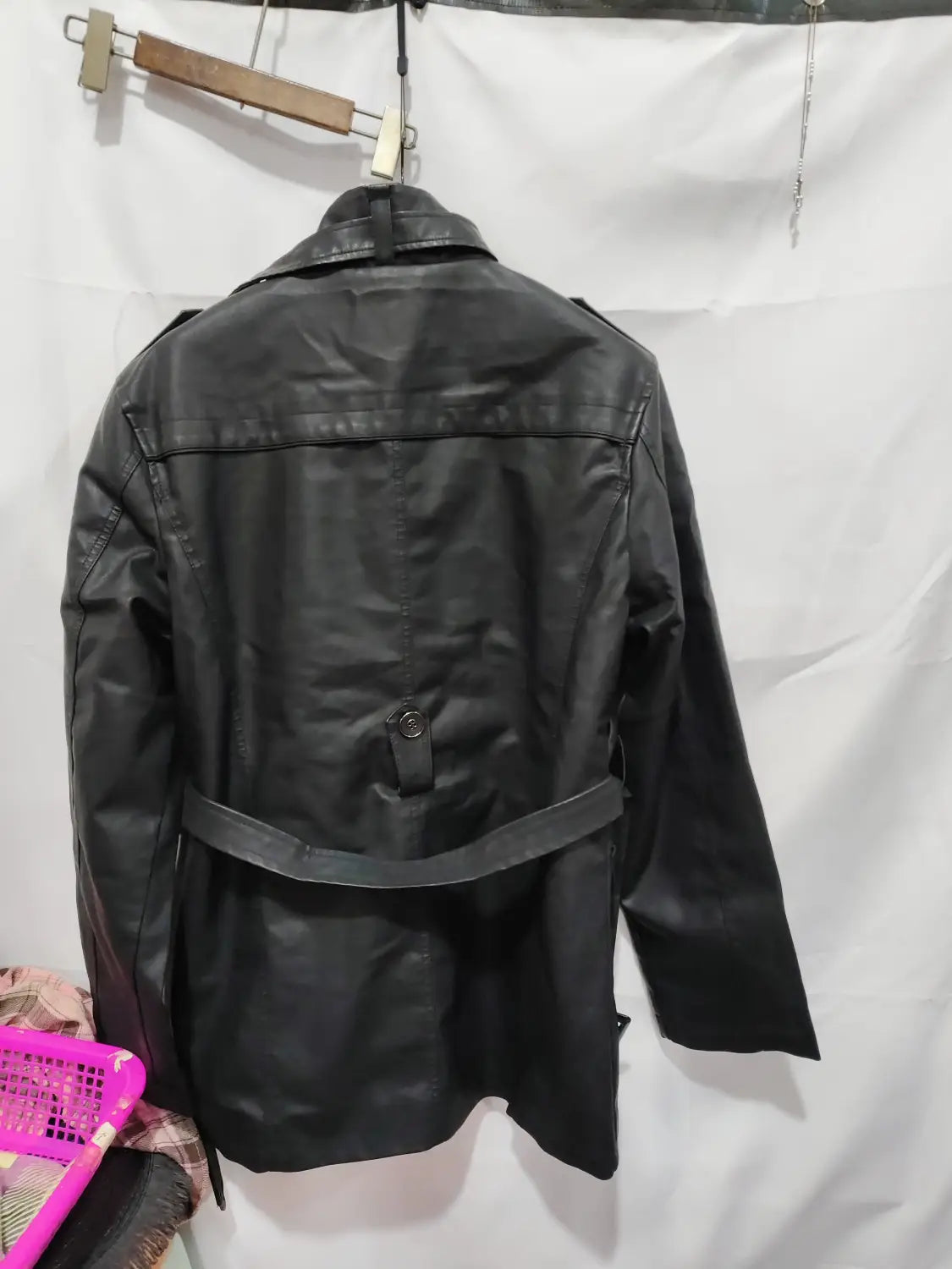men’s black faux leather trench coat with a belted waist and structured shoulders featuring a stand collar.