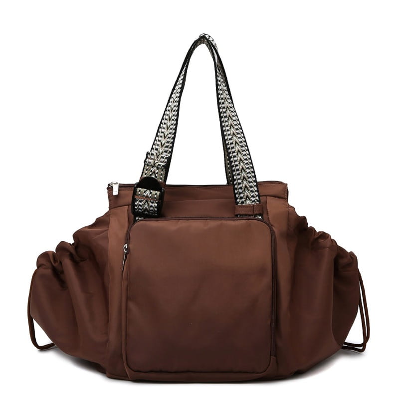 brown nylon multifunctional waterproof duffel bag with black and white herringbone patterned shoulder straps for fashion tote and backpack use