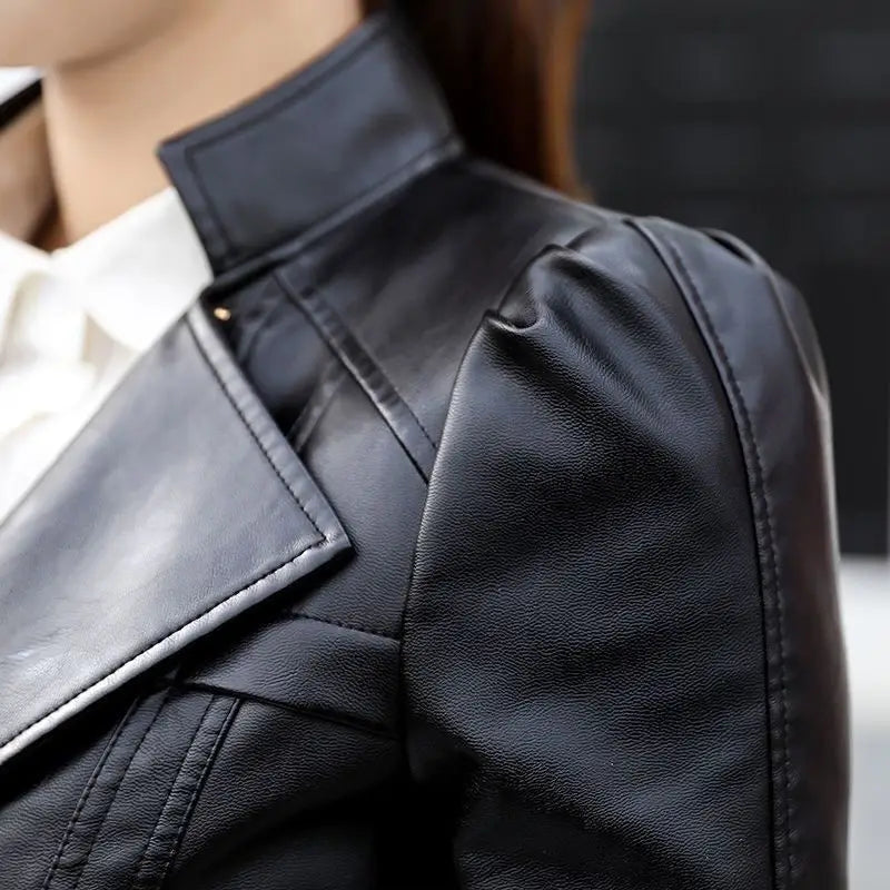 Black faux leather moto jacket with a high collar and structured shoulder puff sleeves shown from the back side.