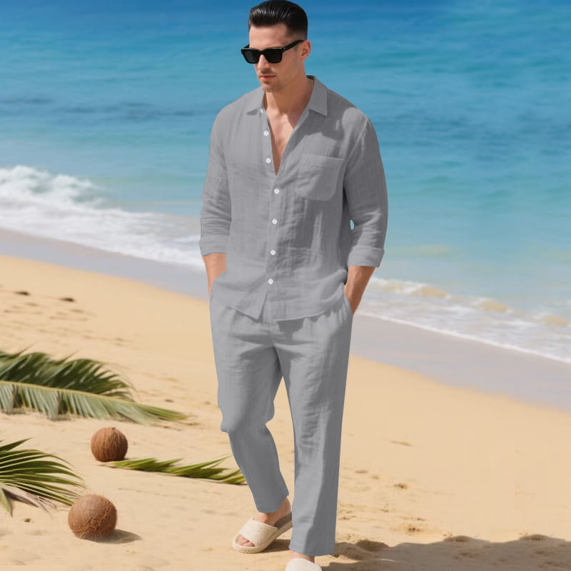 A man wearing a light gray linen men linen long sleeve shirt pants set featuring a button-down shirt and matching pants.