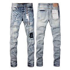 Men’s distressed slim fit patchwork denim jeans in light-wash with distressed patches and a faded worn-in look.