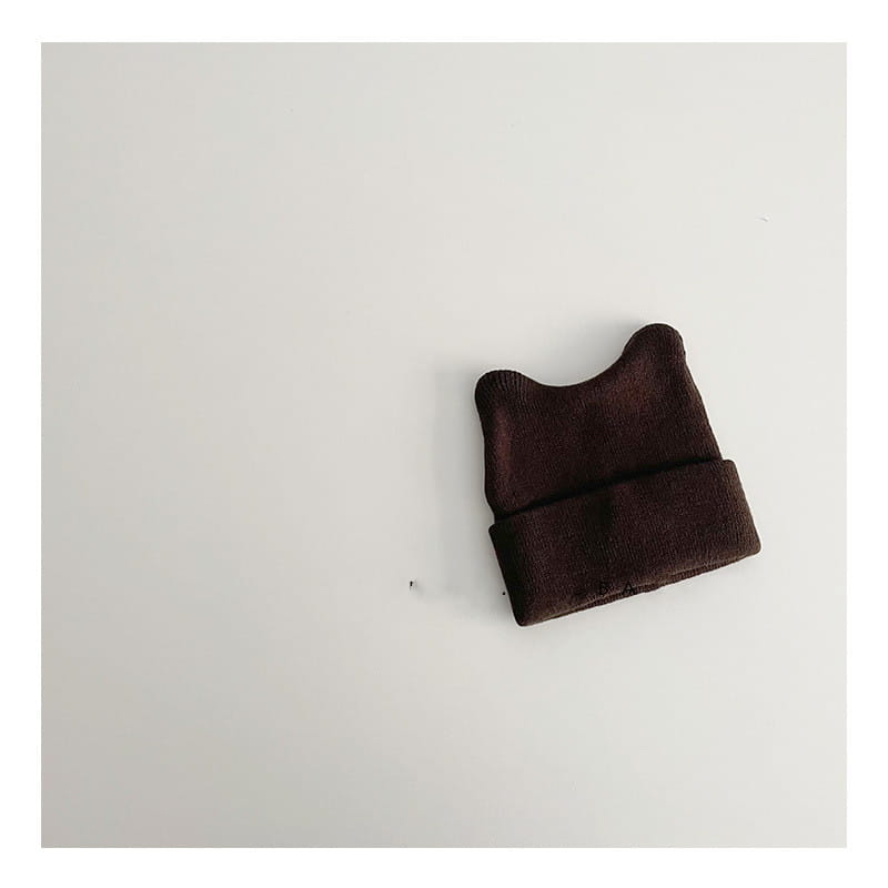 A cozy dark brown knitted childrens beanie hat with a soft plush texture and folded cuff for warm winter wear.