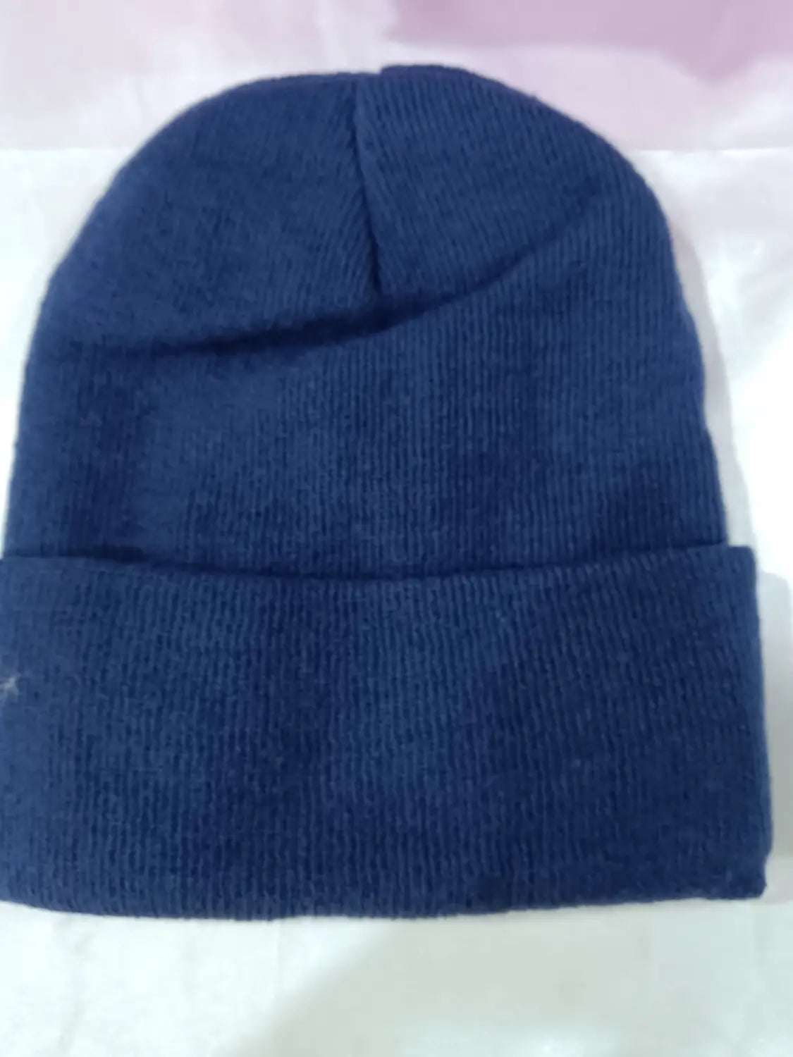 Navy blue satin lined knit beanie with a folded cuff designed as a warm winter hat.