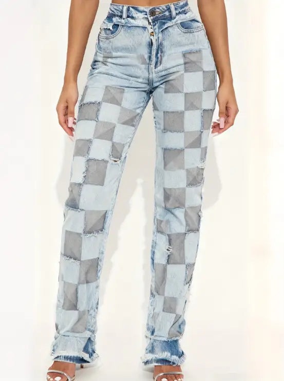 High-waisted straight leg medium wash denim jeans featuring a bold checkered patchwork design with distressed frayed edges and light blue fading.