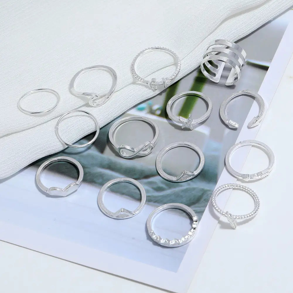 A collection of bohemian silver mixed motif stackable rings featuring silver-toned bands with simple designs and small crystal accents.