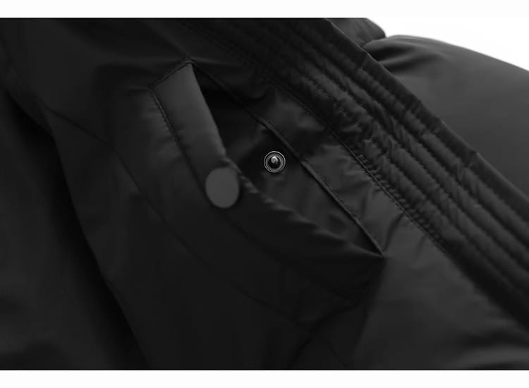 Black quilted hooded puffer cotton coat pocket with a silver snap button and stitched seams.