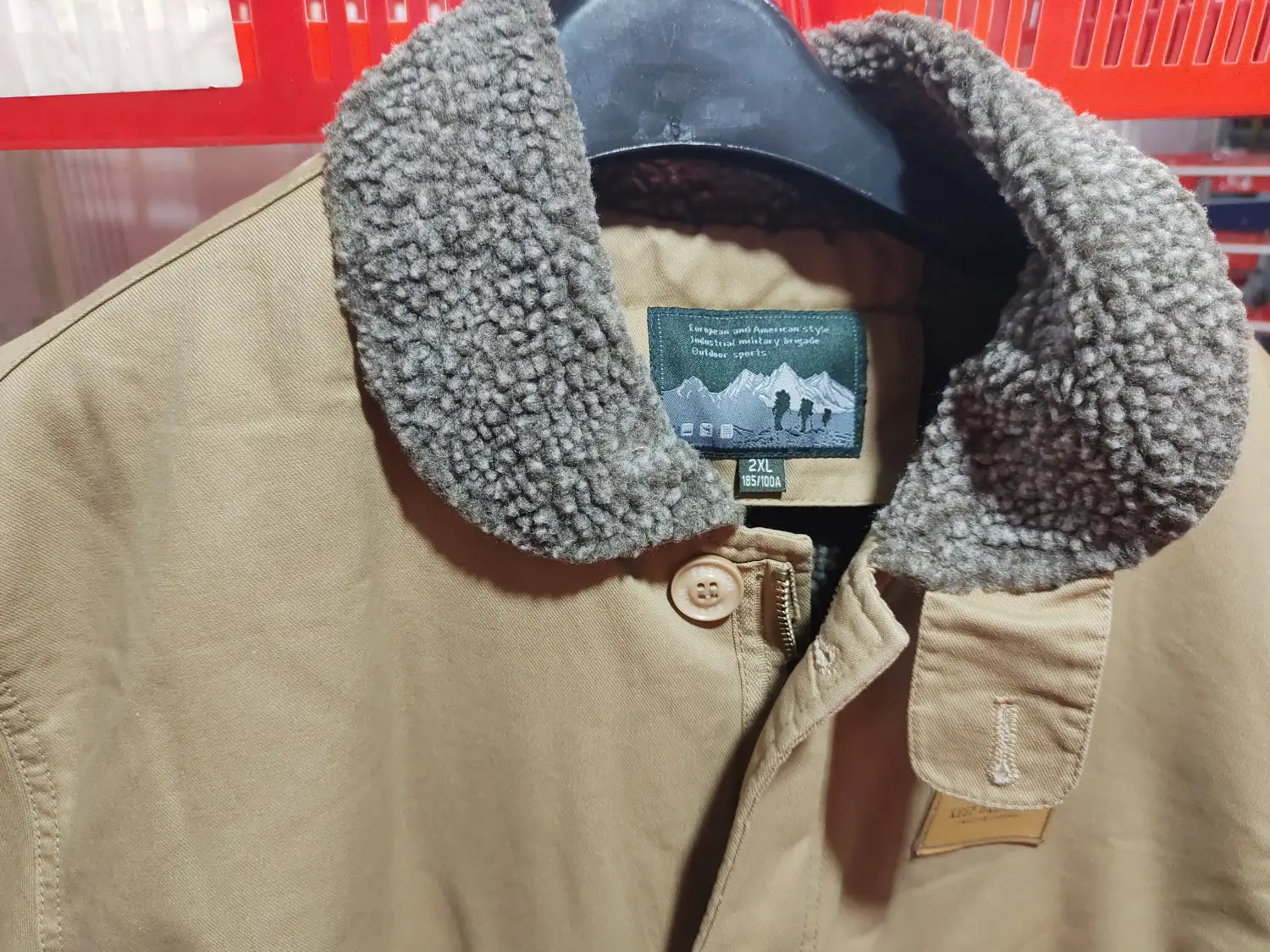 Mens fleece lined winter cotton jacket in tan canvas with a plush gray shearling collar and button closure.