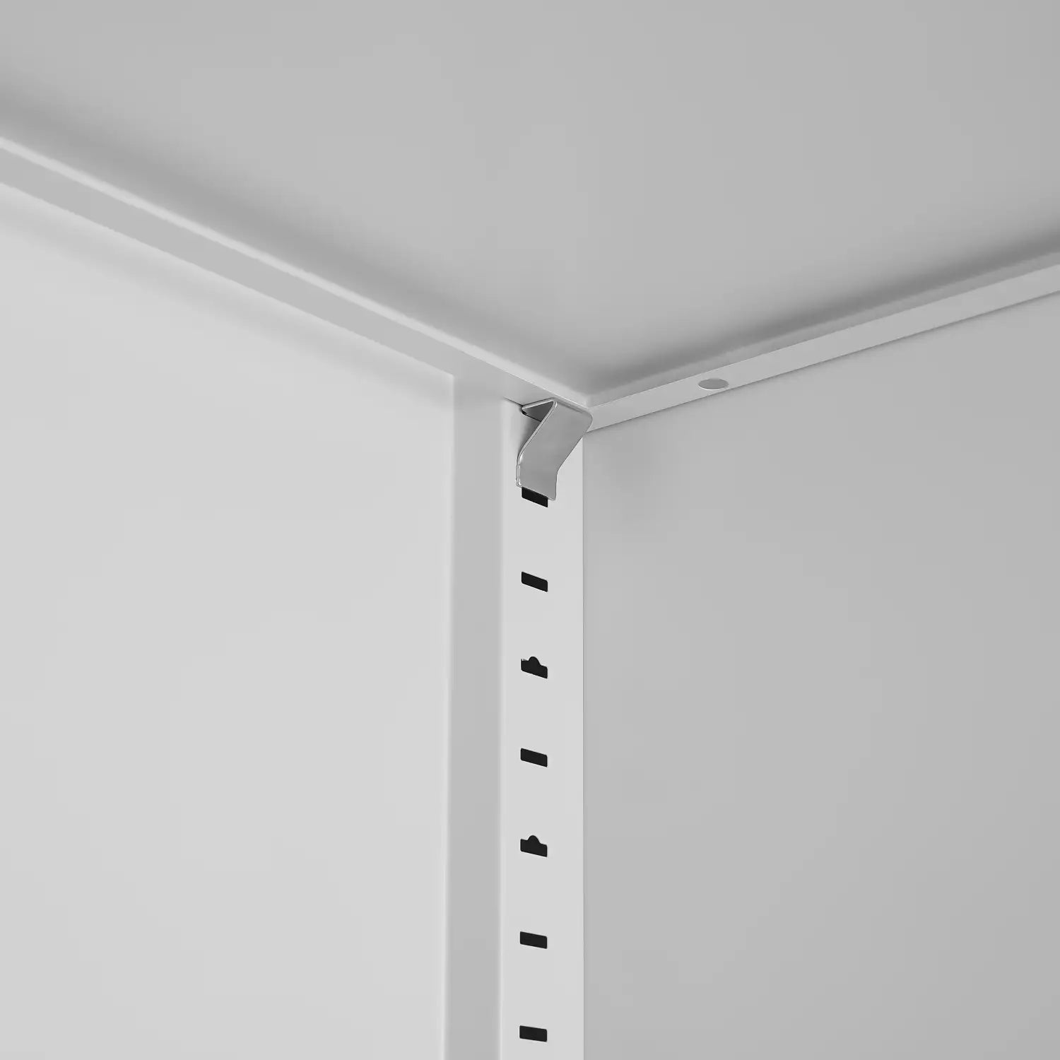 white metal shelf bracket with sleek modern design and evenly spaced black mounting holes on the back side of a steel file cabinet 70 inch 2 door lockable white storage unit