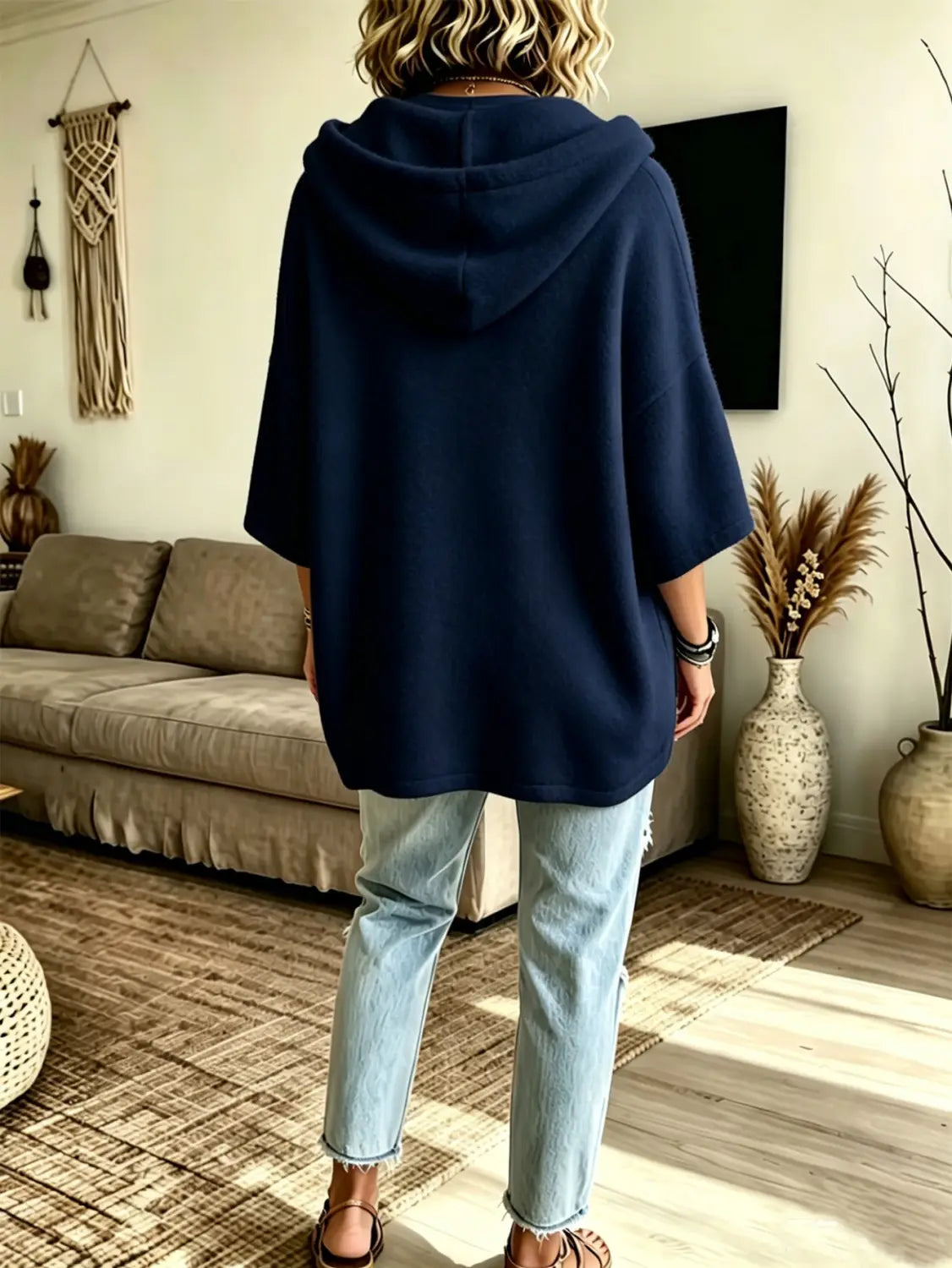 Navy blue oversized fleece hooded top with three-quarter sleeves and a relaxed fit shown from the back side.