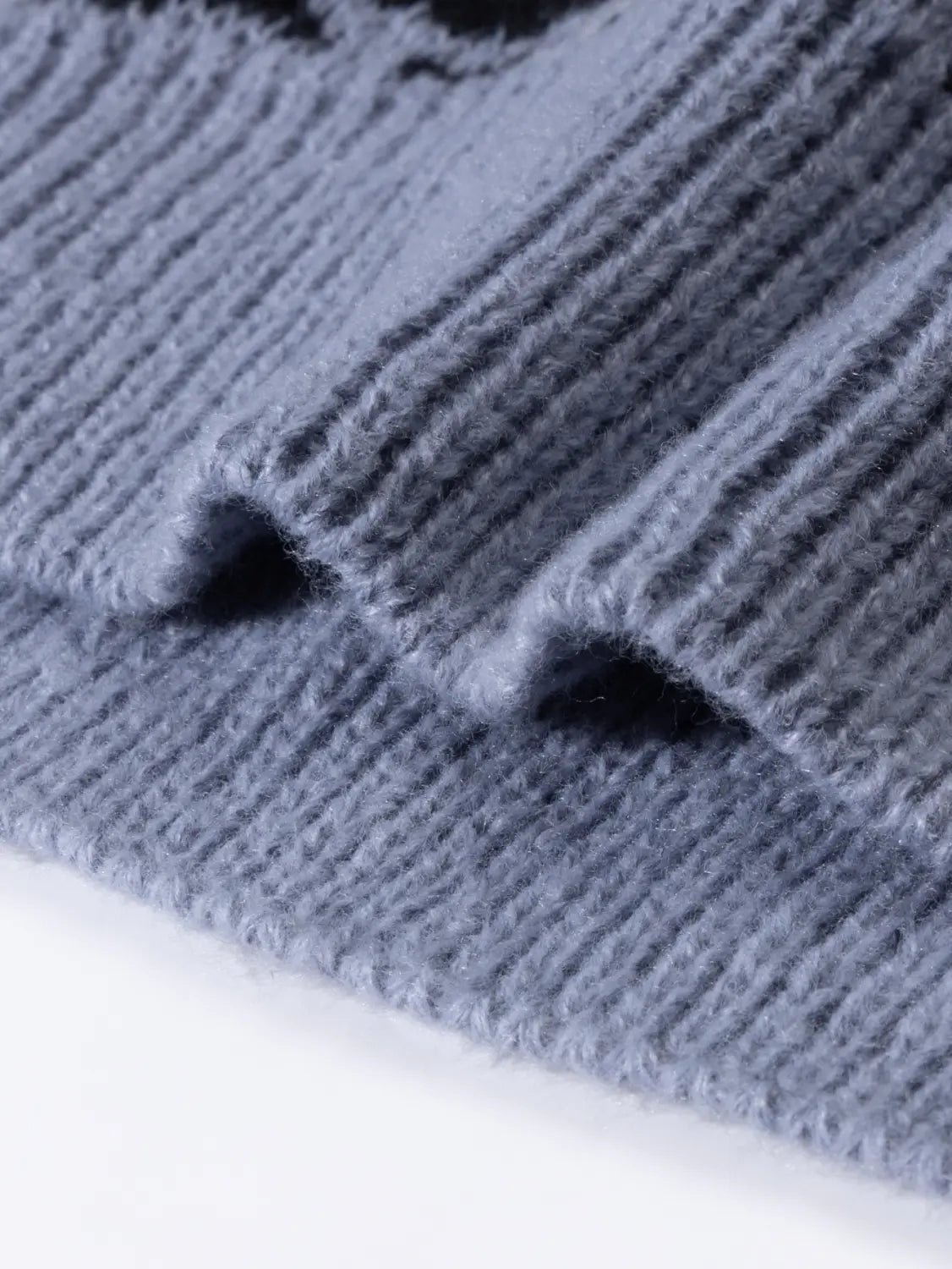 Ein weiches, geripptes Strickmützchen in gedämpftem Blau-Grau, kombiniert mit dem Orca-Strickpullover im Casual-Koreanpullover-Stil