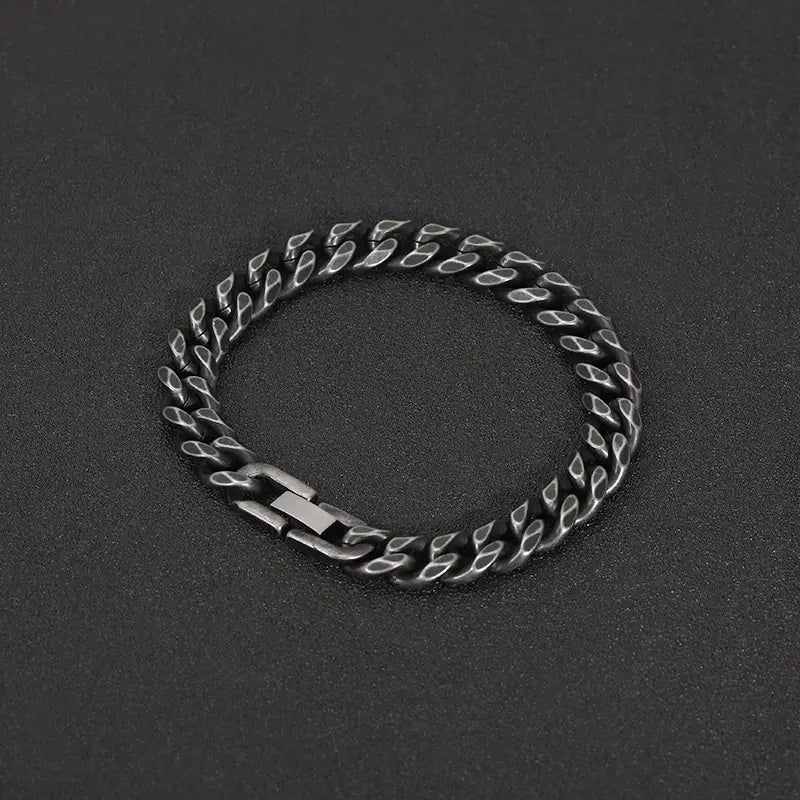 Matte black stainless steel curb chain bracelet with a matte finish and polished edges.