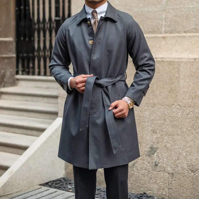 Wool winter trench coat in dark gray featuring a belted waist and gold-toned buttons, single-breasted design.