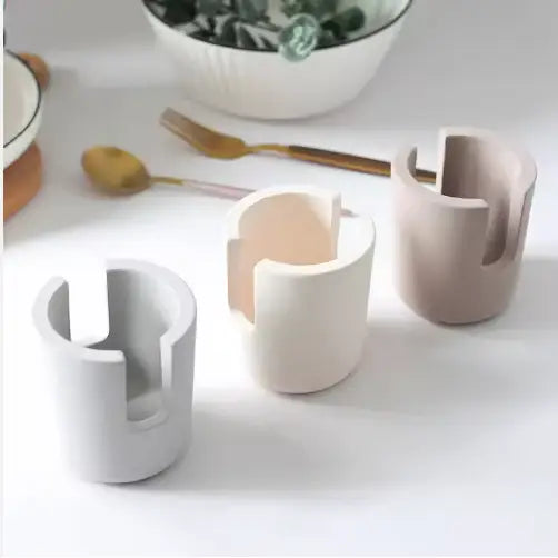 three minimalist ceramic diatom mud sponge rack kitchen sink caddy holders in soft gray beige and off-white with a sleek modern design
