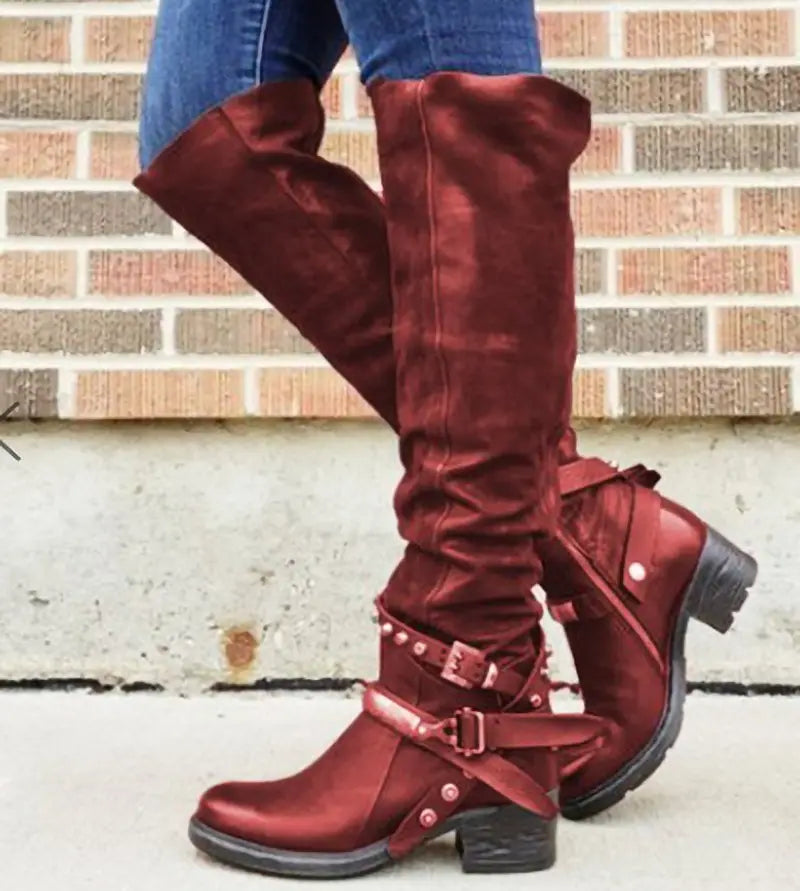 Maroon suede knight boots for women featuring over-the-knee length, metallic buckle straps, and a chunky heel.