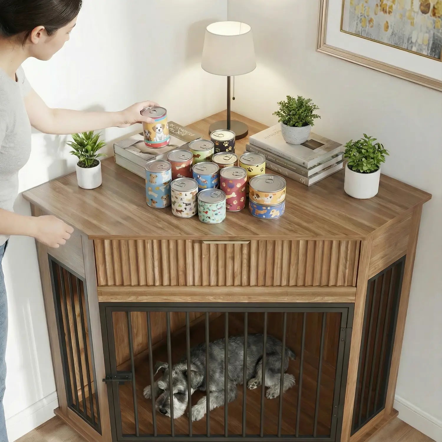 Wooden corner dog crate furniture with fluted storage drawer featuring black metal bars and slatted front panel housing a gray dog resting inside.