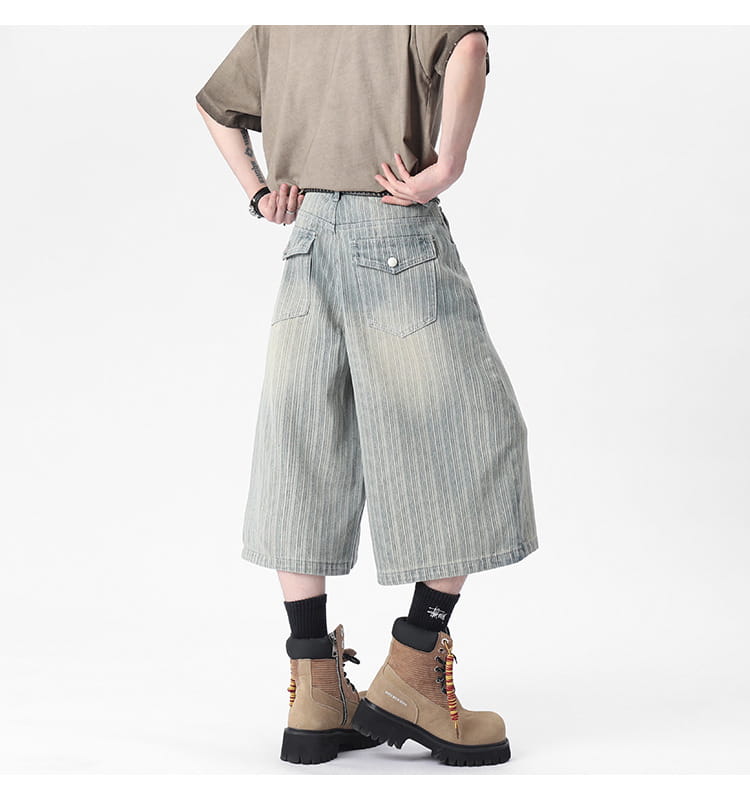 Light-wash denim striped denim capri shorts featuring vertical pinstripes and a wide-leg cut.
