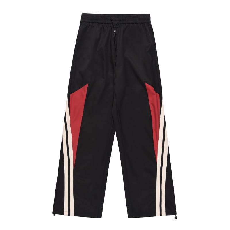 Men’s retro striped athletic track pants in black polyester featuring bold red and white diagonal stripes on the sides suitable for sports and casual wear.