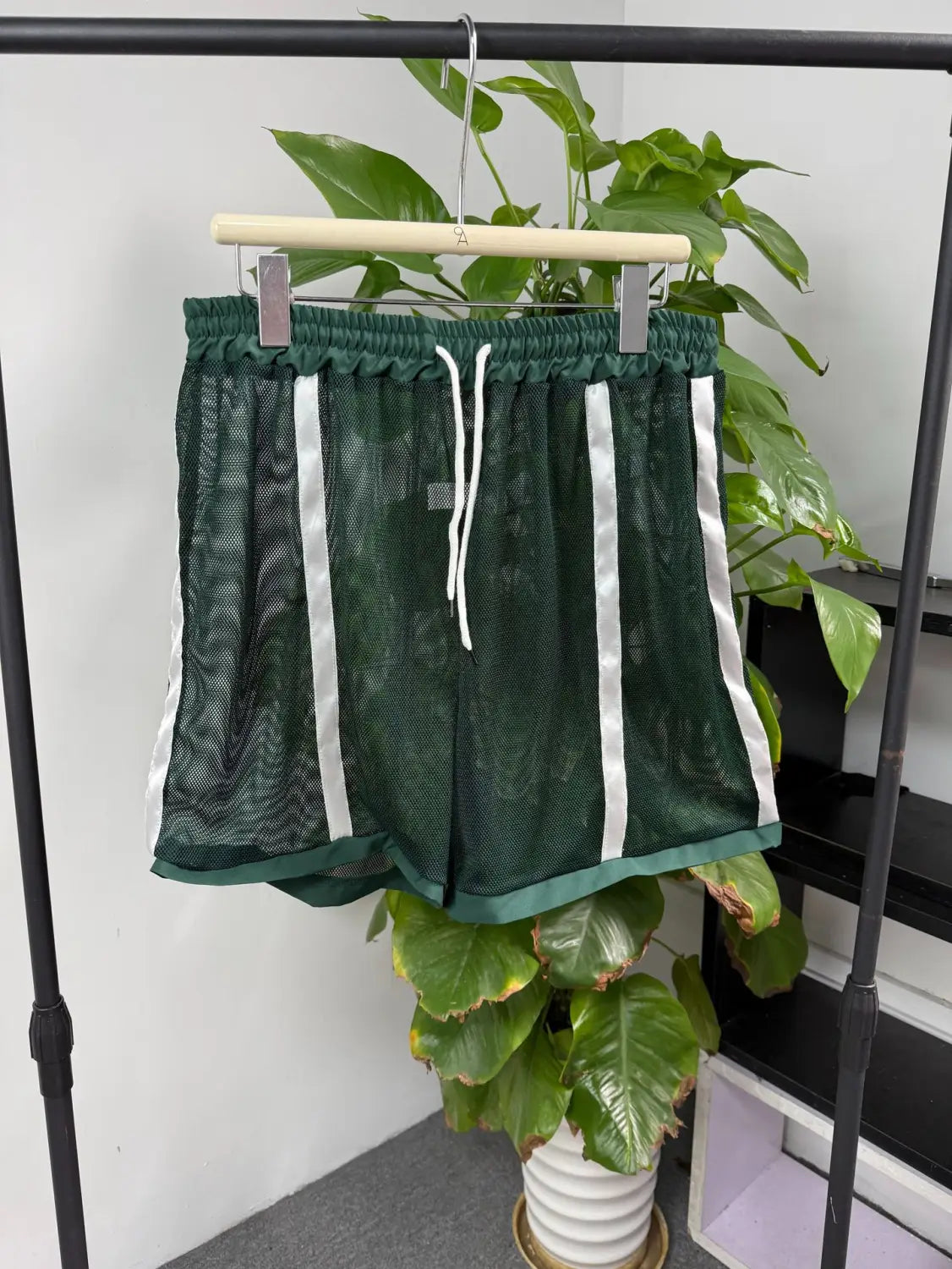 Men quick dry white mesh athletic shorts in dark green with white vertical stripes and a matching drawstring waistband.