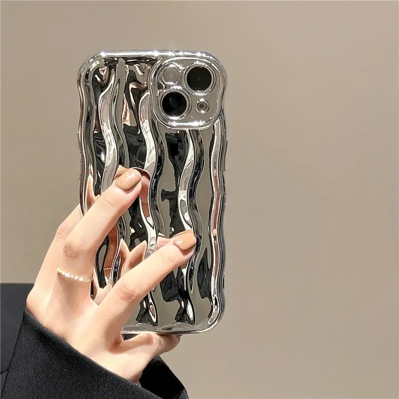 Shiny silver wavy liquid silicone iPhone case showing the back side with a reflective design.