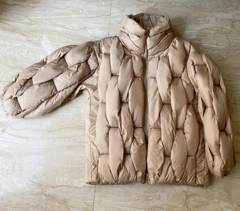 Plus size beige quilted puffer jacket with high collar long sleeves and insulated material for cold weather.