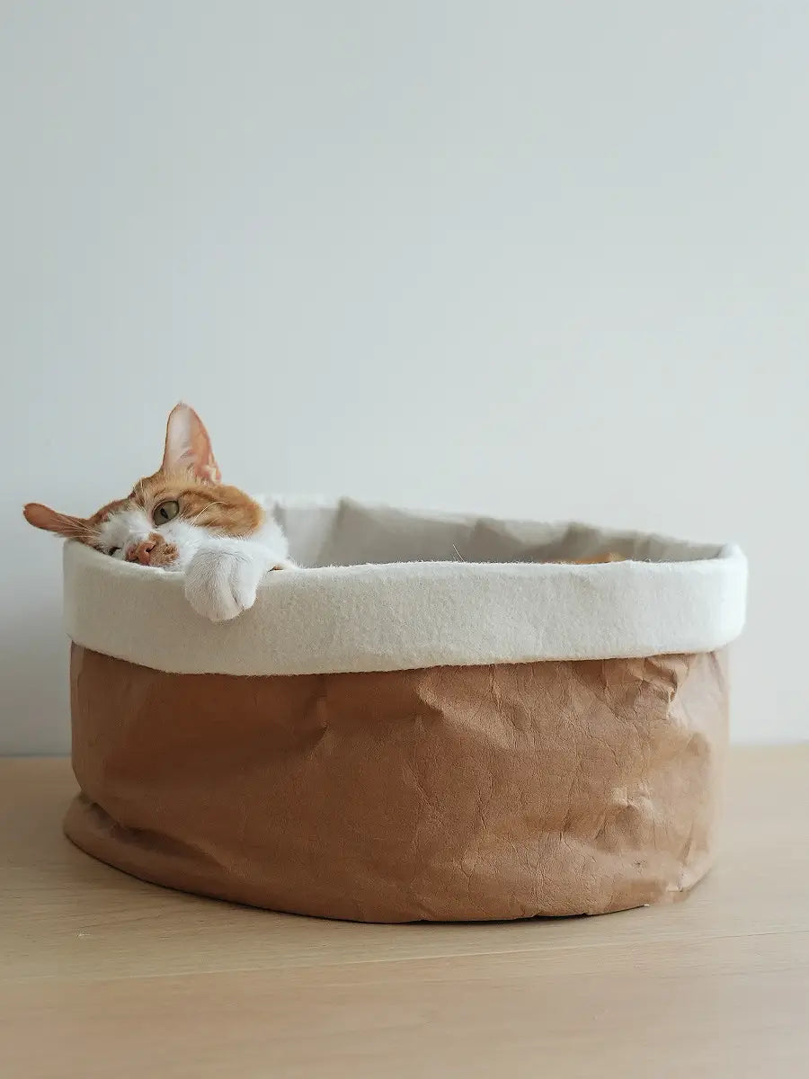 a cozy two-toned round dog and cat nest pet bed with a brown kraft paper exterior and soft white washable interior lining