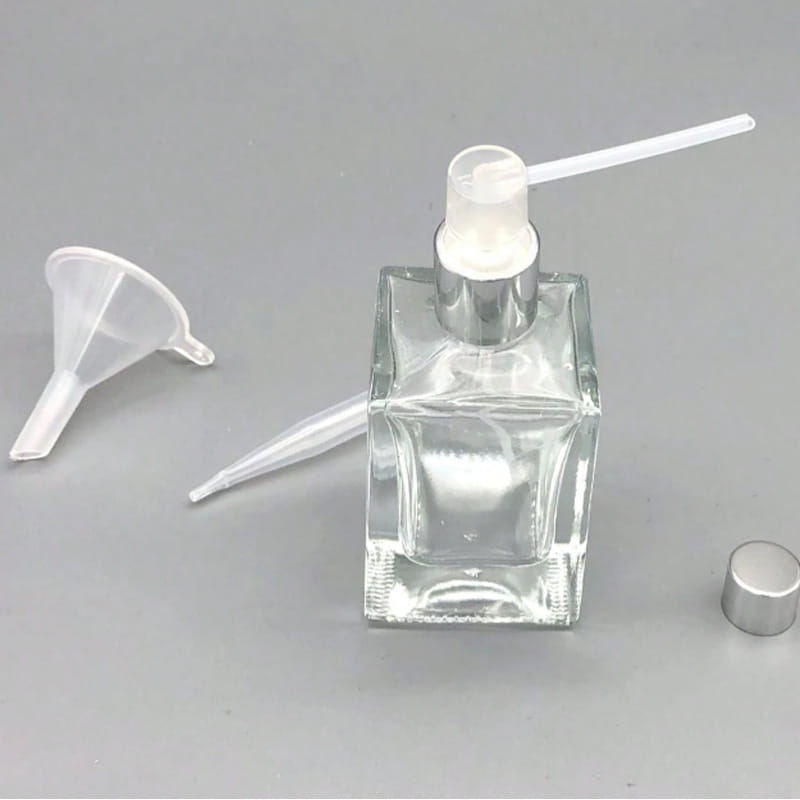 Clear glass square perfume bottle with a silver-toned spray pump and white plastic nozzle included in the essential oil dispenser tool set 3pcs mini funnels.