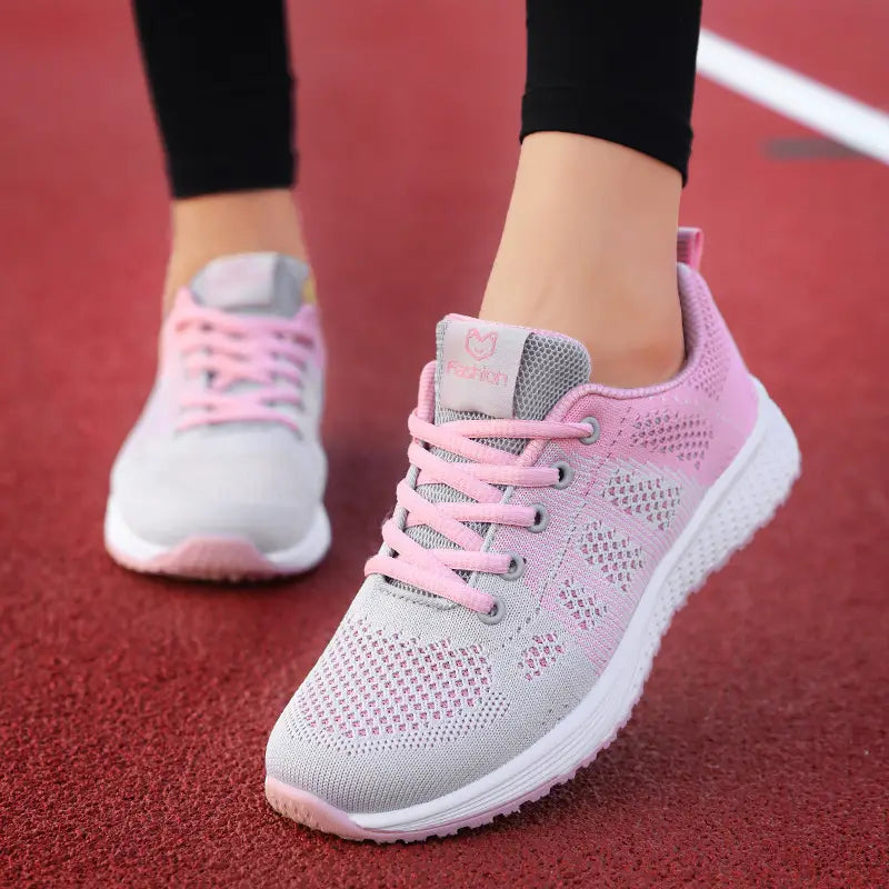 pink and gray mesh fly woven breathable athletic sneakers with white soles designed for sports and casual wear