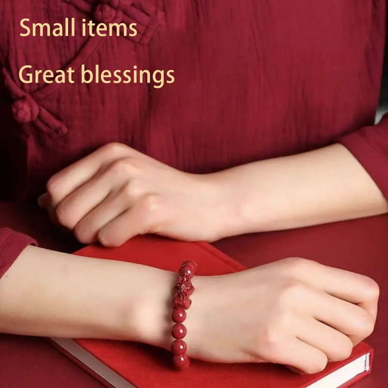 Red jade bracelet featuring intricate dragon carvings as part of the hand carved purple gold cinnabar double pixiu collection.