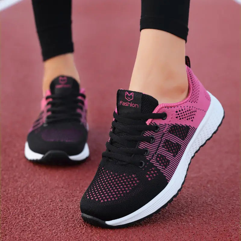 Black and pink mesh fly woven sneakers with white soles and a fashion logo on the tongue designed as breathable athletic shoes.