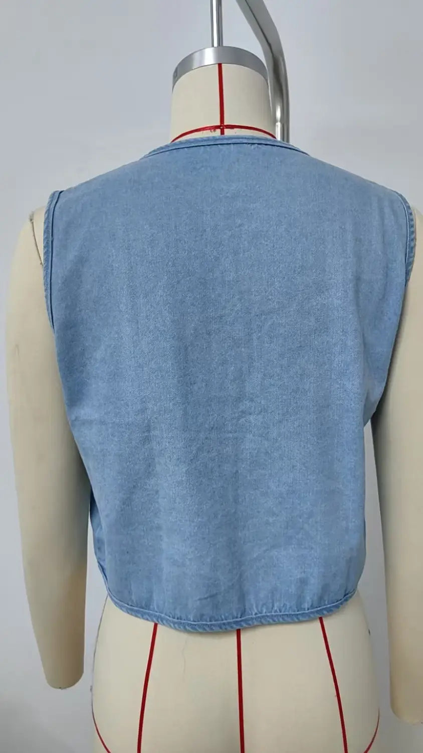 Light blue denim sleeveless vest with bow tie detail displayed on a mannequin as a y2k crop top.