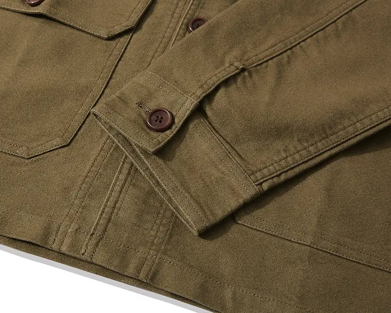 Men’s French workwear jacket cotton utility pocket coat in olive green canvas with brown buttoned cuffs and flap pockets.