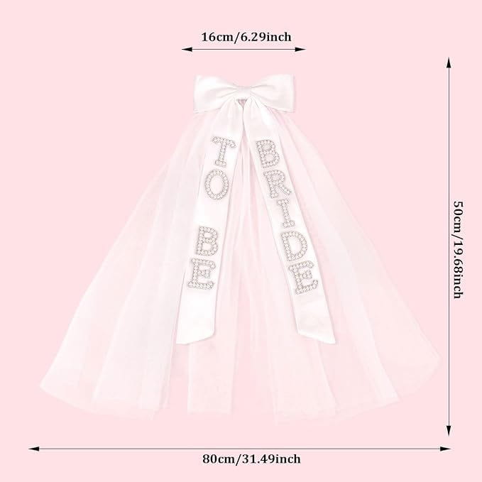A delicate white tulle bridal bow veil featuring sparkling rhinestone lettering spelling to bride and a matching bow at the top.