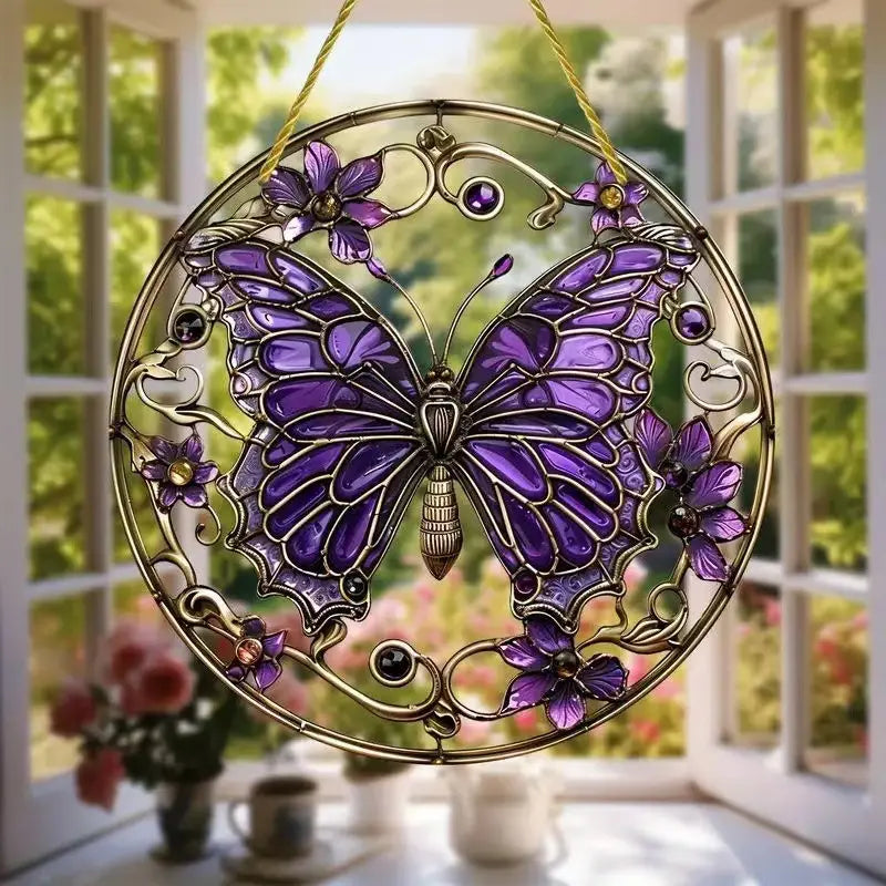 A decorative purple butterfly acrylic wall art suncatcher with intricate gold-toned metalwork and embedded gemstones hanging by a yellow string for floral hanging decor.