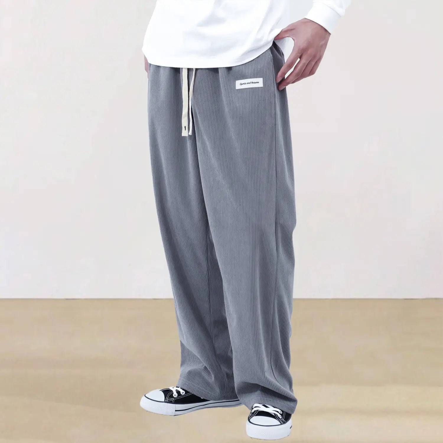 Men’s slim fit gray corduroy wide-leg casual pants with white drawstring and subtle side pocket branding.