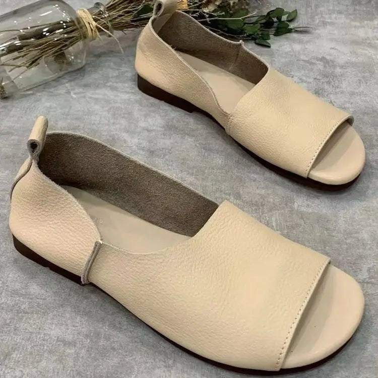 Cream-colored leather slip-on flats with a minimalist design and dark brown soles featured in the leather sandals retro soft sole peep toe slip ons product.
