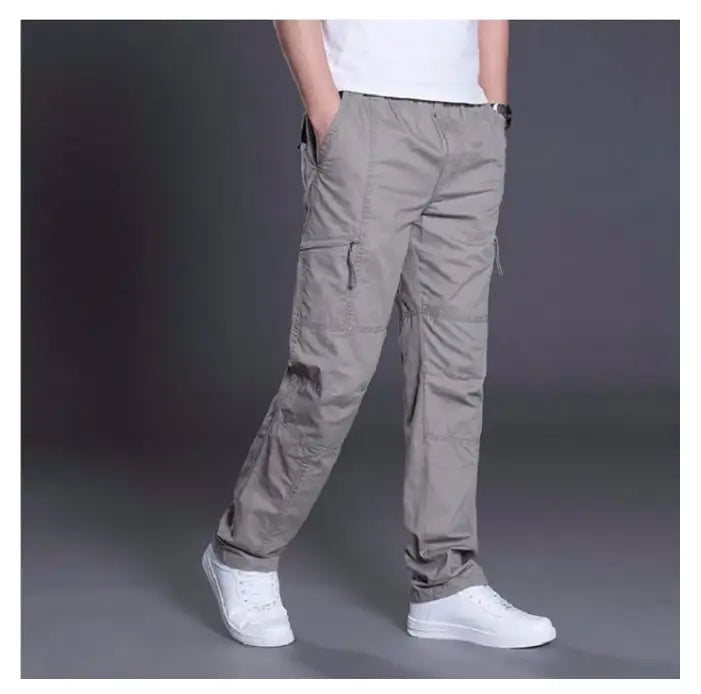 Beige cargo pants made of pure cotton featuring multiple pockets and a relaxed fit for men.