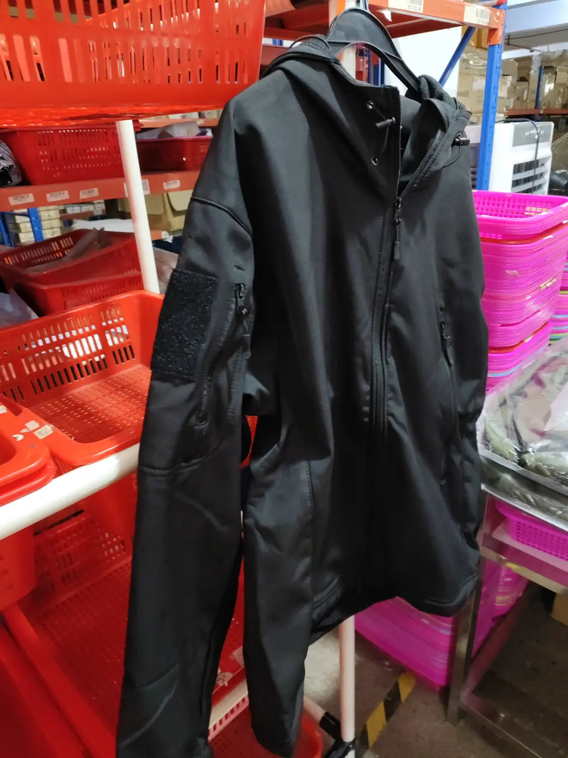 Men’s waterproof tactical fleece soft shell jacket in black with a hood, zippered front, and reinforced elbow patches.