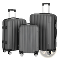 Set of three dark gray hard shell spinner suitcases with vertical ribbed design and silver spinner wheels