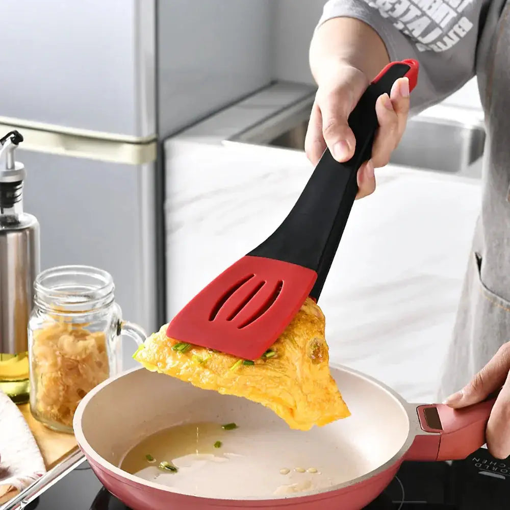 Red and black 3-in-1 silicone slotted spatula with ergonomic handle for versatile kitchen use