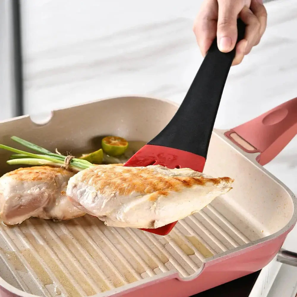 Black and red 3-in-1 silicone slotted spatula with textured grip handle and kitchen tongs clip for versatile cooking tasks