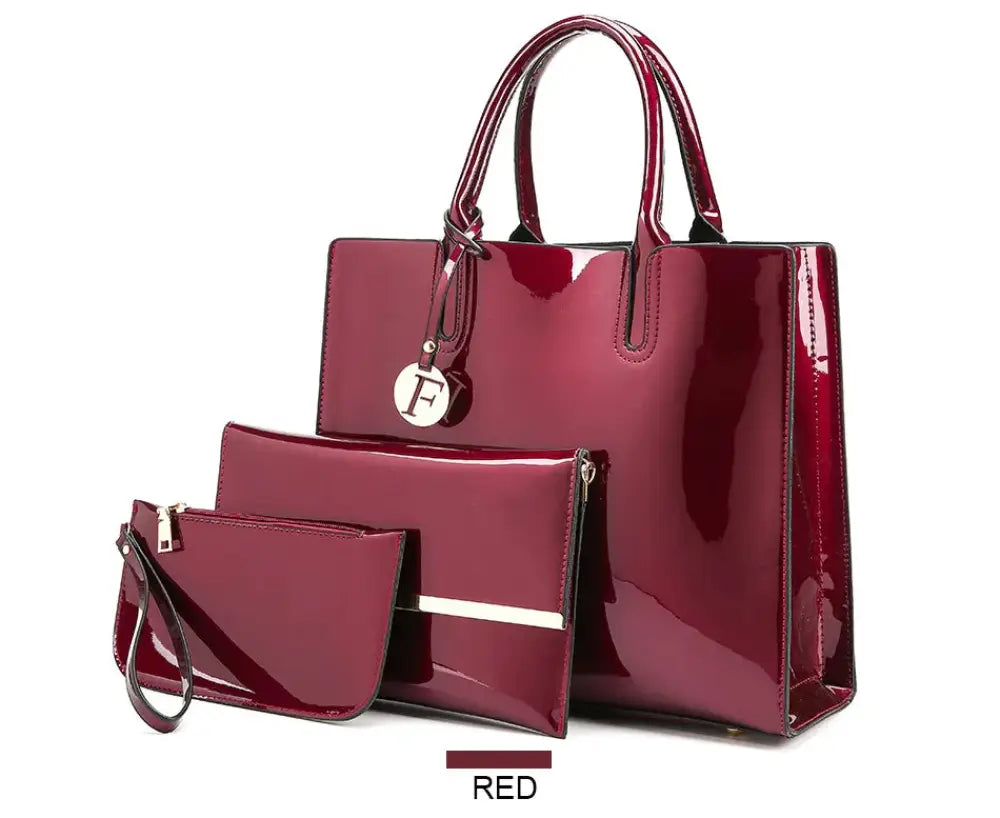 Premium 3-piece crimson leather tote and clutch set featuring a glossy large tote, rectangular clutch with silver stripe, and wristlet