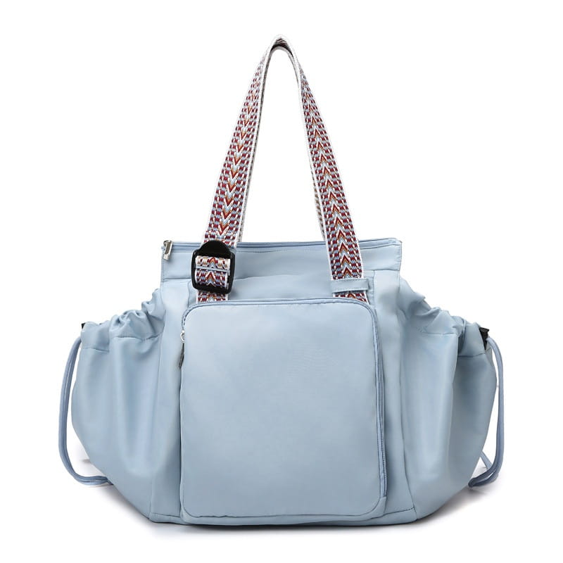 Light blue nylon multifunctional waterproof tote bag with patterned woven straps and a front zippered pocket.