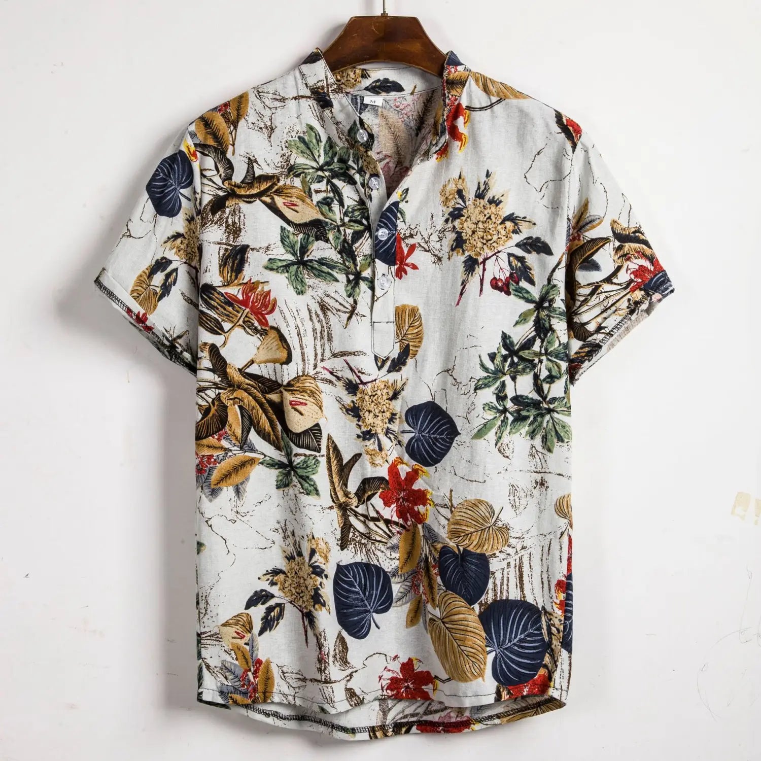 Men slim fit tropical floral short sleeve button shirt in white featuring a vibrant tropical pattern with green, gold, and navy blue leaves.