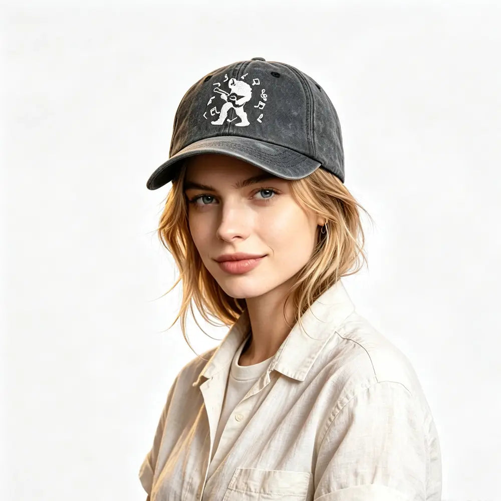 Dark gray distressed baseball cap featuring a white embroidered graphic of a guitarist surrounded by musical notes from the Bigfoot Guitar Vintage Distressed Hat collection.