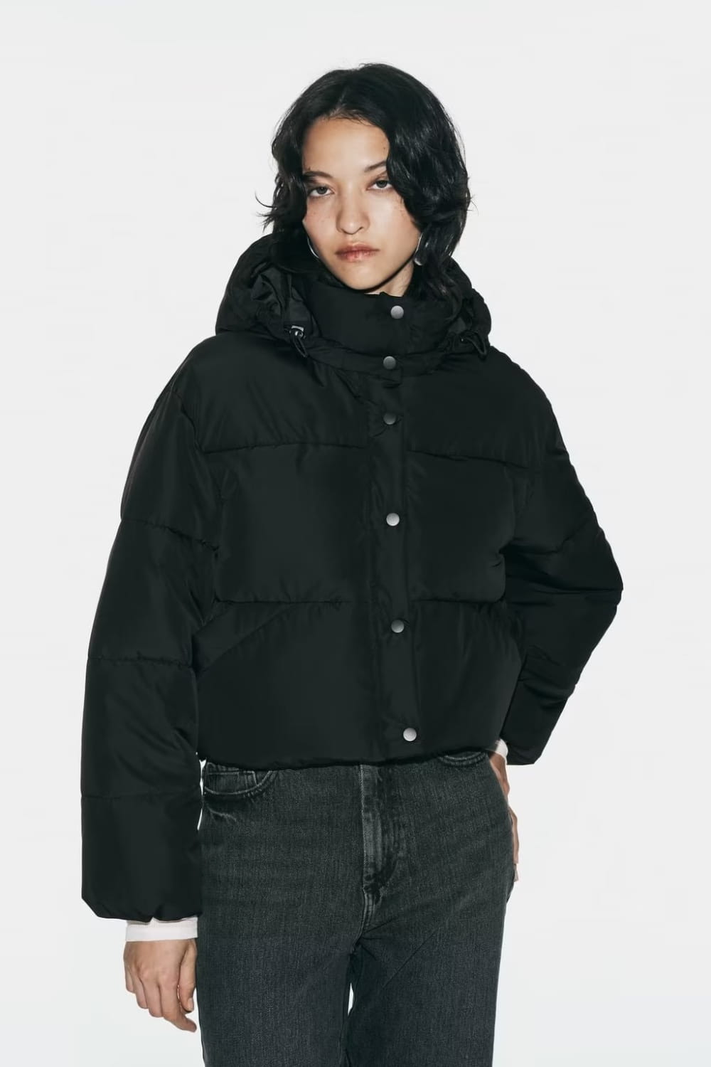 black quilted hooded puffer coat featuring a black puffer jacket with a hood and button closures