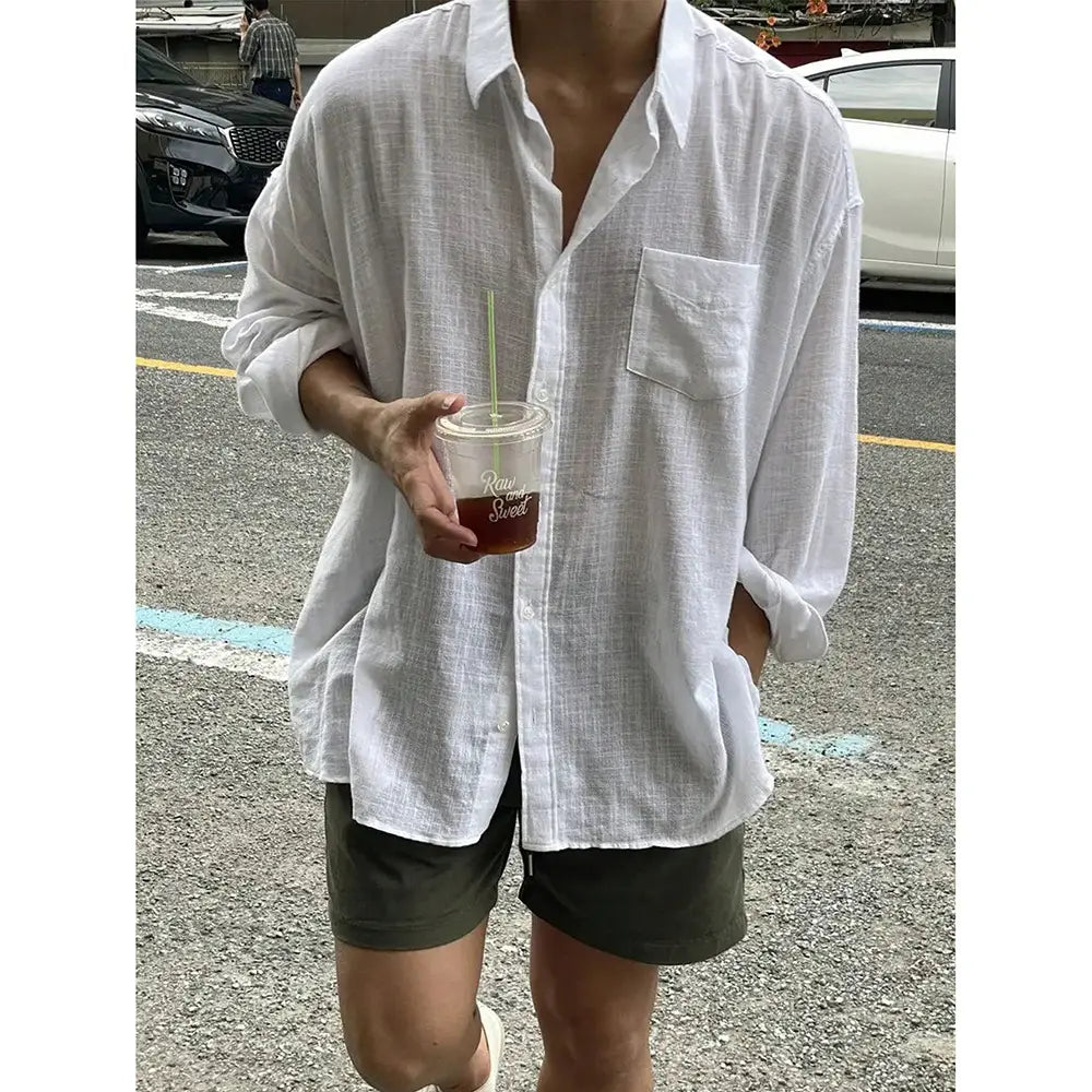 Korean style white linen button up shirt featuring a loose fit and a chest pocket.